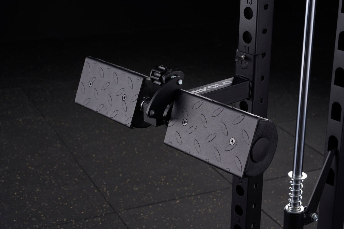 Black Mikolo lat pull and row attachment with two diamond-plate textured pads mounted on a power rack upright