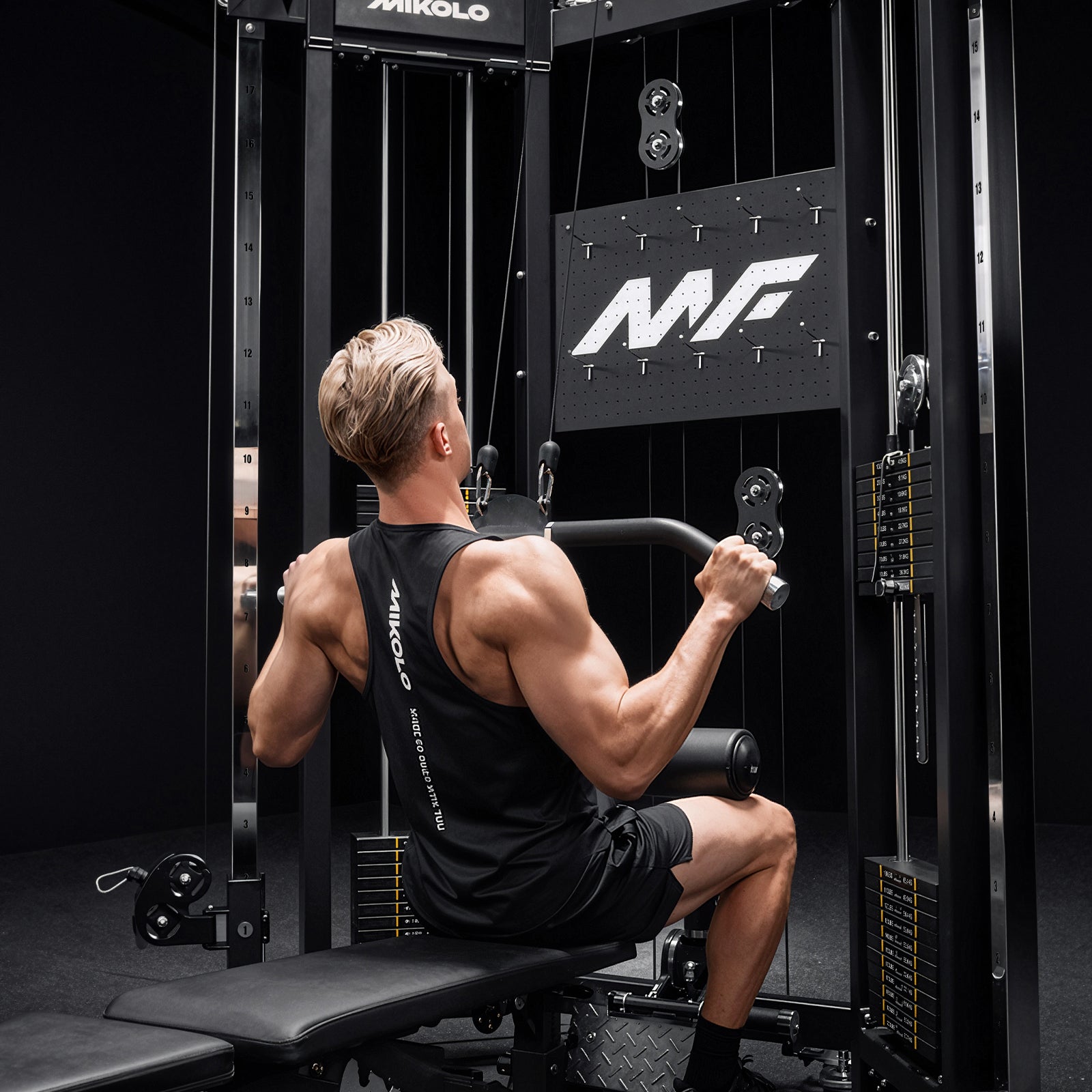 A user performing lat pulldowns on the Mikolo FALCON™-2.0 Functional Trainer Lat and Row System