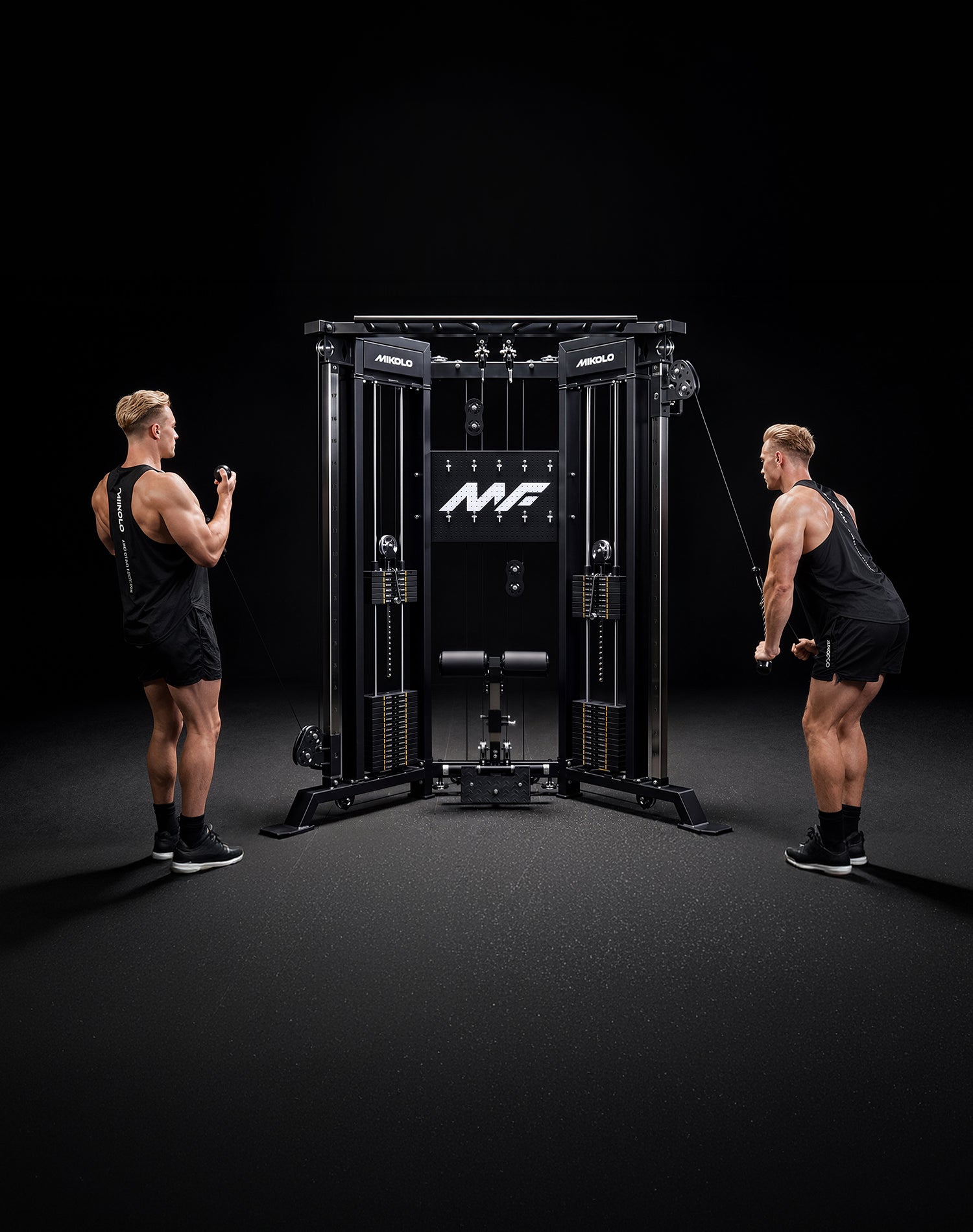 Full-length view of two users performing cable workouts at the same time on the Mikolo Falcon 2.0 Functional Trainer in a home gym