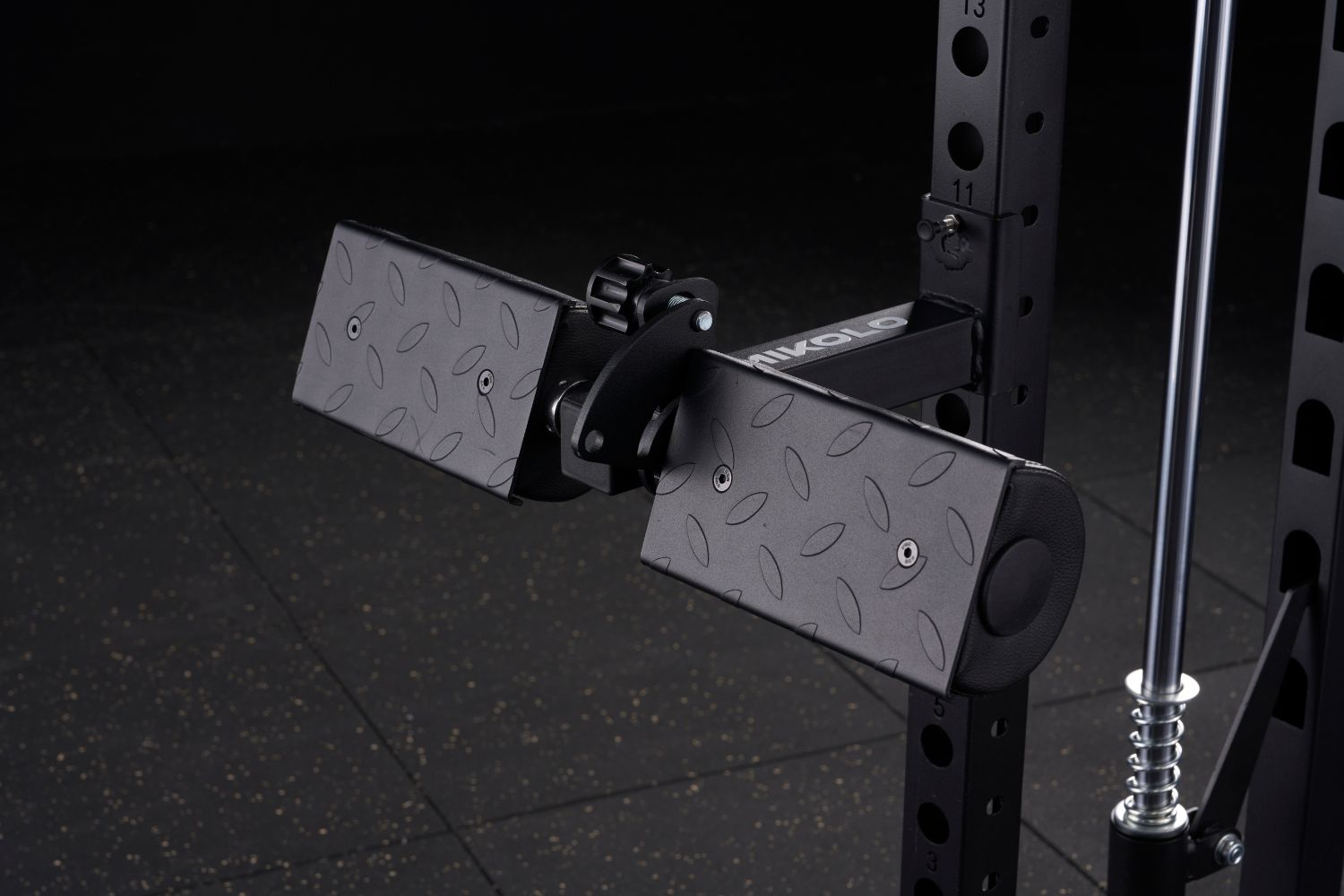 Black Mikolo lat pull and row attachment with two diamond-plate textured pads mounted on a power rack upright