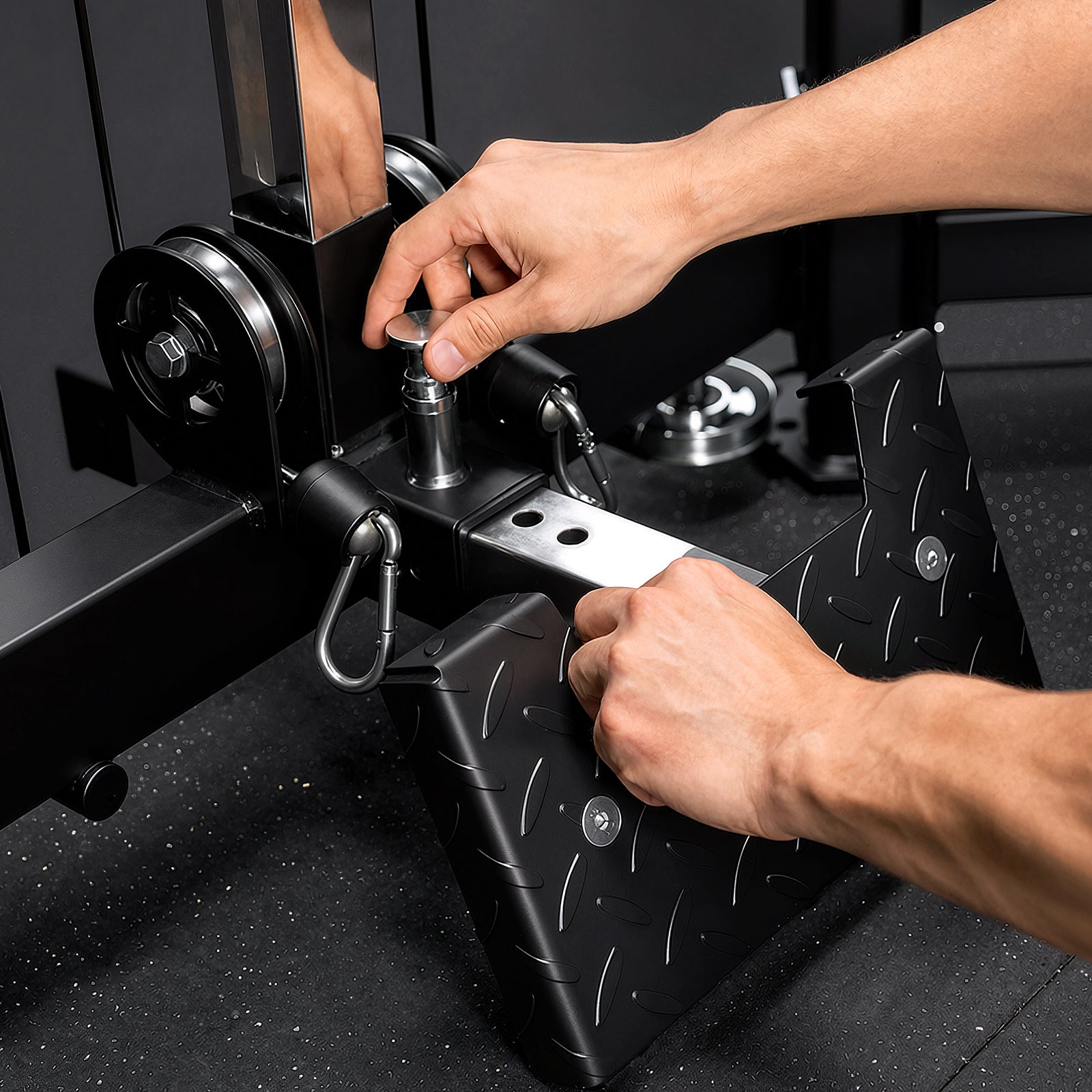 Close-up of adjusting the low row foot plate on the Mikolo FALCON™-2.0 Functional Trainer