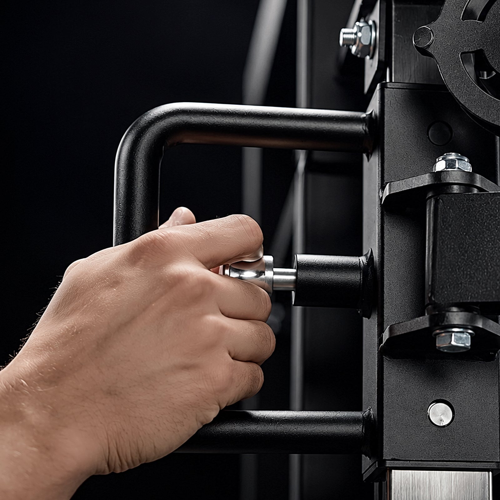 Close-up of the one-handed quick-adjust pop pin on the Mikolo FALCON 2.0 Functional Trainer slider