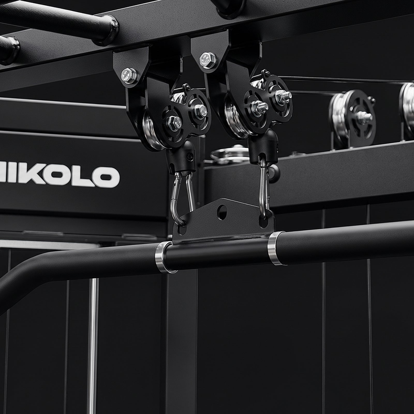 Close-up of the top dual pulley system showing the 1:1 and 2:1 cable ratio adjustment on the Mikolo FALCON 2.0
