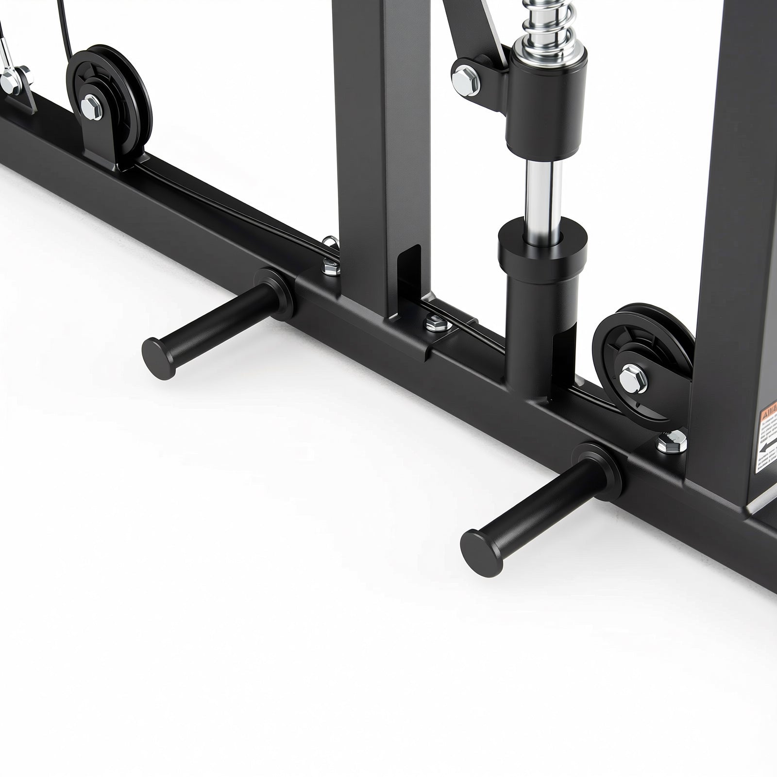 Lower section of a black gym machine frame showing horizontal pegs, cable pulleys, and a silver hydraulic piston