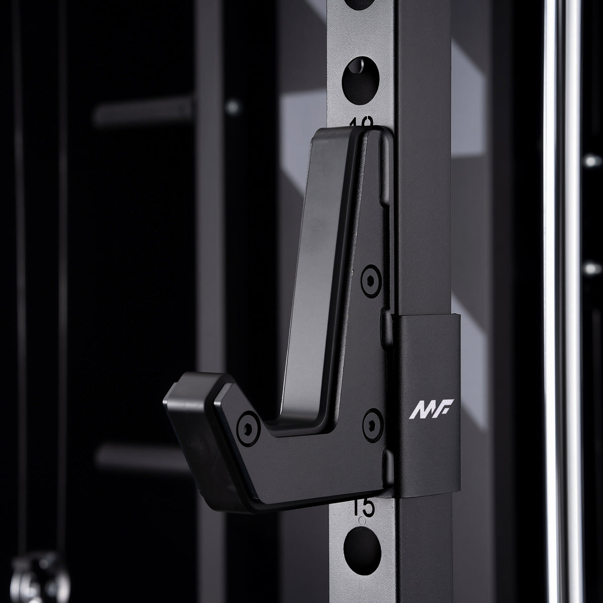Black metal J-hook barbell holder attached to a power rack upright post, featuring a U-shaped cradle and white MF logo on the