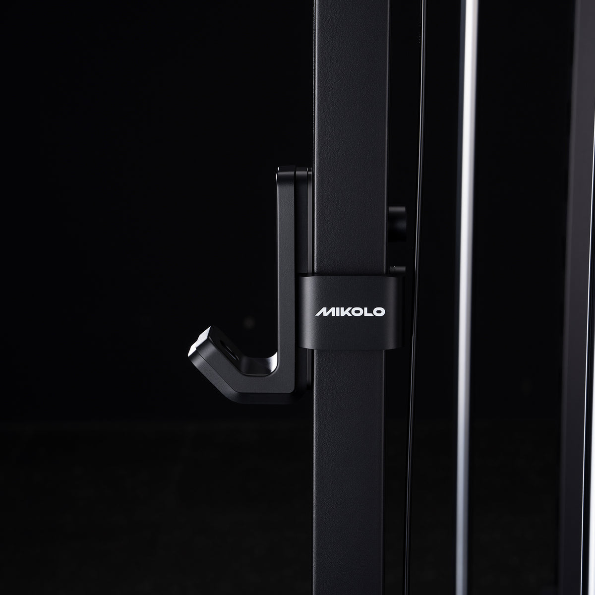 Black metal J-hook attachment with white MIKOLO logo mounted on a vertical rack post