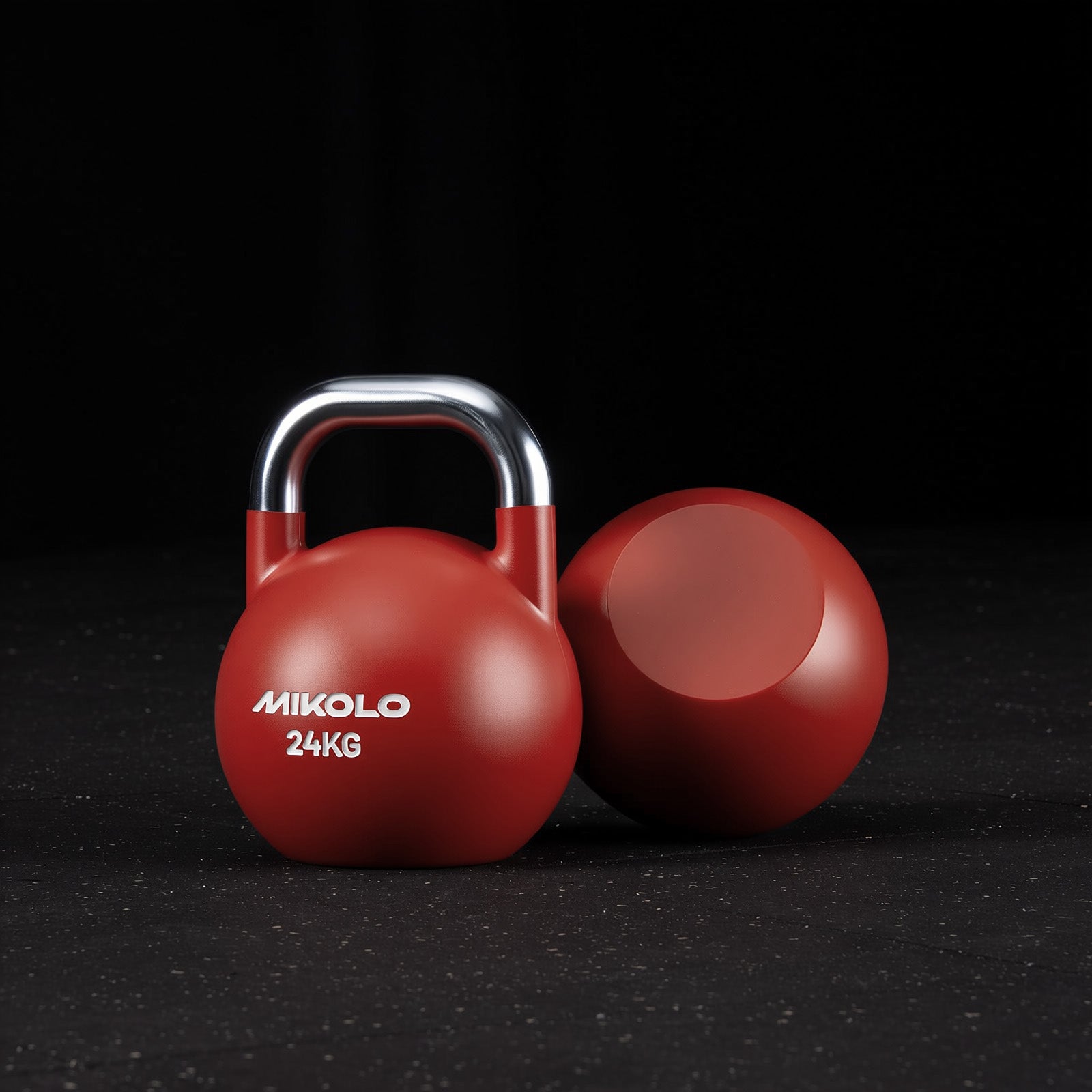 Red Mikolo 24kg kettlebell with a silver handle standing upright next to a view of its flat circular base