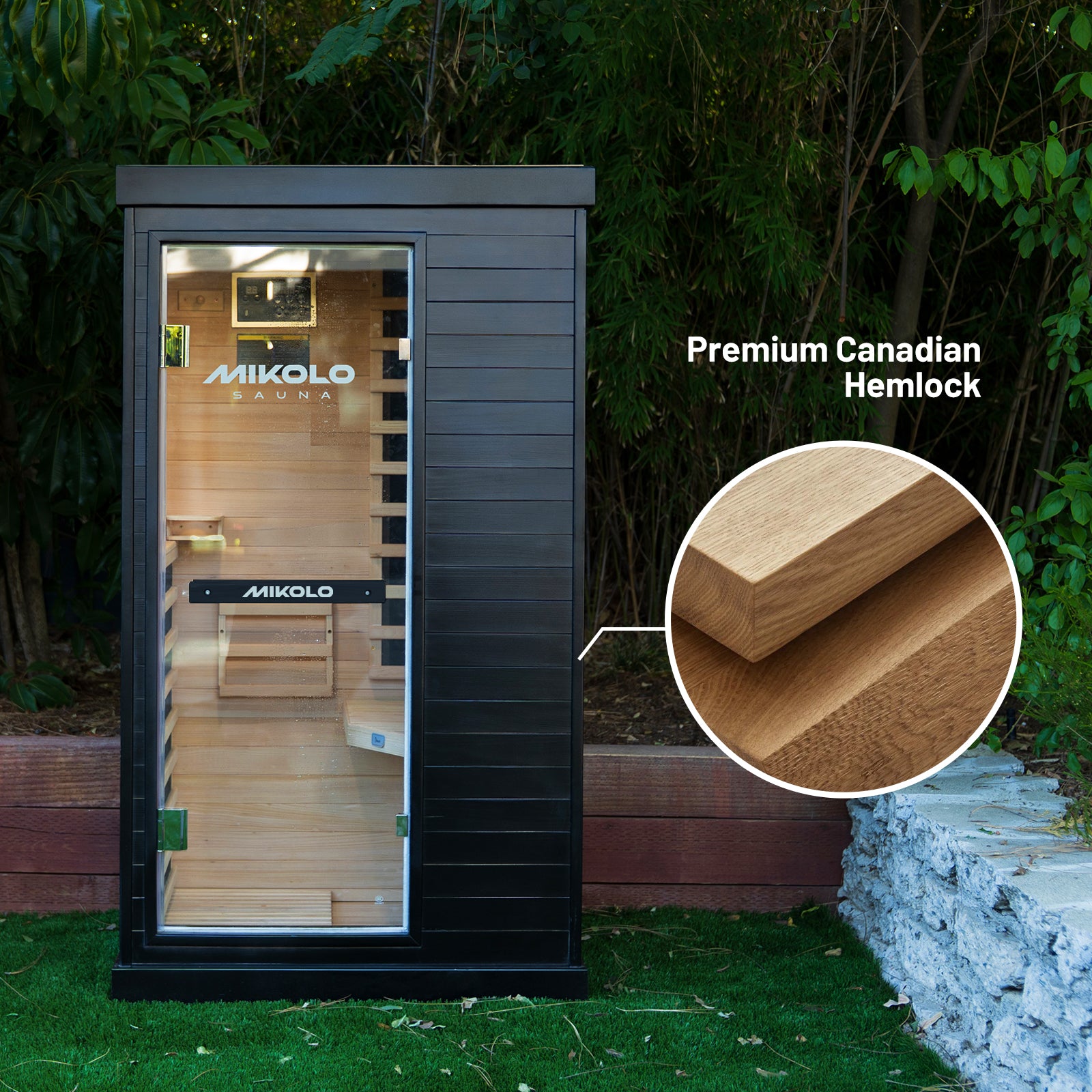 Black MIKOLO infrared sauna with glass door on grass, featuring a magnified inset showing Premium Canadian Hemlock wood grain